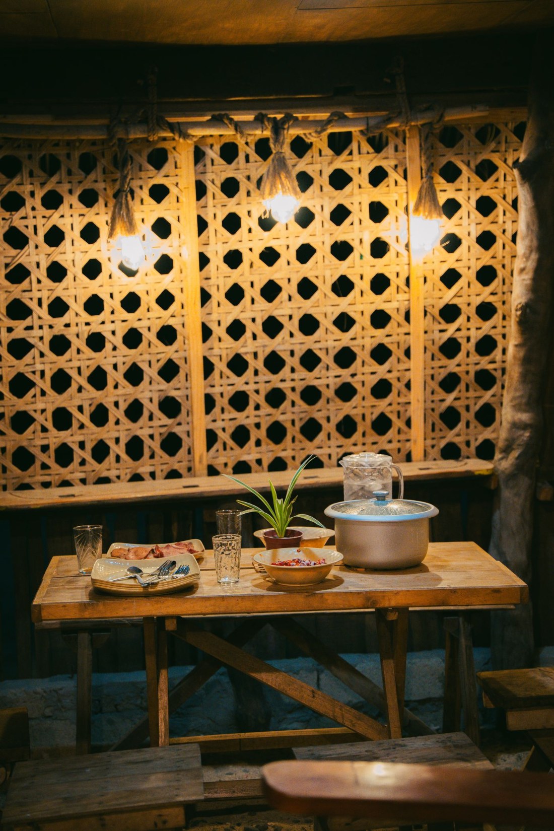 A woven wood lattice screen set into a warmly lit room